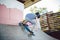 Skater boy rides on skateboard at skate park ramp. Kid practising skateboarding outdoors on skatepark. Youth culture of leisure