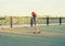 Skater caucasian women on skateboard at sunrise