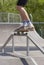 Skater doing 50-50 grind on fun-box in skatepark