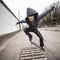 Skater doing ollie over wooden crate