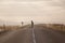 Skater on empty road with maks in Iceland. Great light in the ba