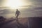 Skater on empty road with maks in Iceland. Great light in the ba