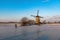 Skater on the frozen canal along the windmills alignment