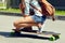 skater with a longboard closeup. trendy casual hipster person a skateboard.