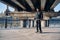 Skater rides on skateboard at empty concrete embankment on the urban background