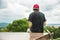 Skater sits with his back and thinks next to the skateboard