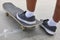 Skater and skateboard legs detail. Lifestyle urban background