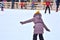 Skating rink. The girl first goes on skates.