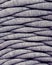 Skein of gray knitted yarn close-up. macro photography background texture pattern weave fiber textile fabric. strips of fabric are