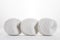 skein of white cotton yarn on a white background. Three identical balls