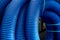 Skeins of blue corrugated pipe close up
