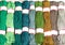 Skeins of polyester cord in various bright colors of green and beige