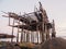 The skeleton of a fishing shed on the beach. Abandoned house against the Arctic sky. Old authentic village of Teriberka