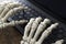 Skeleton hands typing a report using a keyboard - Halloween Concept