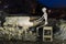 Skeleton plays piano on a cold spooky night in a desert ghost town