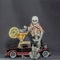 Skeleton sitting on classic car holding car keys a