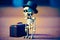 Skeleton wearing top hat and holding suitcase with suitcase behind it