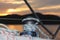 Skeleton winch on board a sailing cruise yacht. The view from the cockpit on the sunset background. Quiet and calm morning