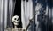 Skeleton in the window. Halloween scenery. Terrible holiday at home. Halloween in the USA. Traditions and house decor