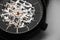 Skeleton wrist watch with black clock face, macro photo