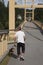 Skelleftea, Norrland Sweden - August 18, 2020: elderly man walking his dog over a wooden bridge