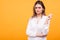 Skeptical beautiful young girl over yellow background