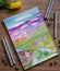 Sketchbook with hand drawn marker illustration of colorful countryside landscape.