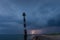 Skew lighthouse in the Baltic Sea. Stormy night and lightning.