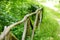 Skewed and weathered wooden fence on the edge of a meadow