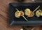 A skewer of seared hokkaido scallops with lemongrass flavouring served with curry cauliflower sauce