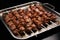 skewered lamb meat on a metal tray