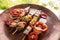 Skewered meat prepared on grill with vegetables. Barbecued shish kebab or shashlik on sticks