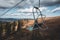 Ski chair-lift in front of blue sky in sunny day. No people. Elevator in autumn