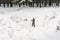 Ski girl climbing uphill in winter forest