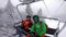 Ski holidays - Couple in ski lift doing selfie video. Ski winter vacation concept. Skiing on snow slopes in the