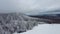 Ski holidays vacation concept with ski lift in winter landscape with snow and snow covered trees. Beautiful day at ski