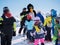 Ski instructor in penguin suit studies young skiers. Ski resort in Alps, Austria, Zams on 22 Feb 2015. Skiing, winter season, moun