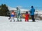 Ski instructors with their young pupils.