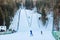 A ski jumper flying from a ski jumping hill tower