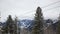 Ski lift on a background of snow-capped mountains. Empty chairs move against the backdrop of a beautiful mountain winter