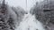 Ski lift in idyllic winter landscape with snow and trees. Beautiful snowing weather on extremely cold day at ski resort