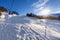 Ski lift in mountain with paths from skies and snowboards