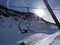 Ski lift sit above ski empty slope in italian Dolomites in winter sunny blue sky day