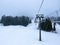 Ski Lift snowy mountain winter forest with chair lift At The Ski Resort in winter. Snowy weather Ski holidays Winter