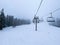 Ski Lift snowy mountain winter forest with chair lift At The Ski Resort in winter. Snowy weather Ski holidays Winter