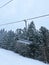Ski Lift snowy mountain winter forest with chair lift At The Ski Resort in winter. Snowy weather Ski holidays Winter