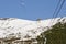 Ski lift in snowy mountains