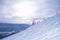 Ski lift with snowy trees and blue sky. Sheregesh.