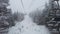 Ski lift winter landscape with snow and trees. Beautiful snowing weather on extremely cold day at ski resort with