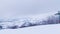 Ski lifts on the background of snow-capped mountains and a mountain glacier. Empty single chairs move up and down on